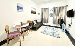 a living room with a table and a couch at LoveCo Vacation house close to Dahilayan with private parking in Manolo Fortich