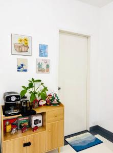 a room with a wooden cabinet with a microwave on it at LoveCo Vacation house close to Dahilayan with private parking in Manolo Fortich