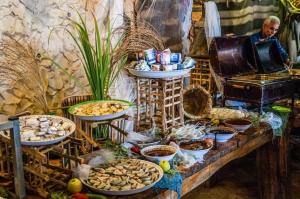 a table with many plates of food on it at Kfar Hanokdim - Glamping & Camping in Arad