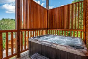 a hot tub on the deck of a cabin at Hibearnator in Sevierville