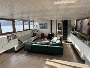 a living room with a couch and a table at Stunning boat with a view in Amsterdam