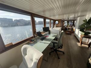 an office with a desk and a computer on a boat at Stunning boat with a view in Amsterdam