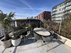 a patio with a table and chairs on a balcony at Stunning boat with a view in Amsterdam