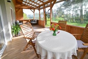 a table with a vase of flowers on a porch at Grape House Kintai in Kintai +76 photos