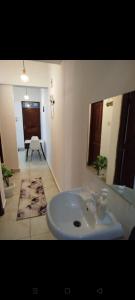a bathroom with a white sink and a mirror at Vescon 1 in Mombasa