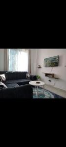 a living room with a black couch and a table at Vescon 1 in Mombasa