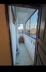 a view of a balcony with a chair in a room at Vescon 1 in Mombasa