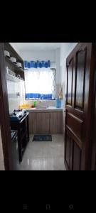 a kitchen with a sink and a window in it at Vescon 1 in Mombasa