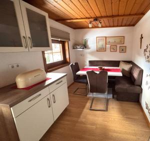 a small room with a kitchen and a dining room at Ferienhaus Niederbichler in Gnesau +6 photos