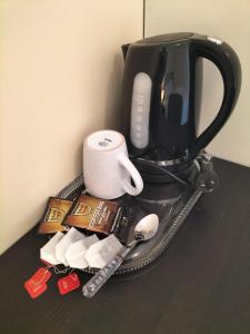 a counter top with a coffee maker and a cup at Maisie Haven in Brisbane