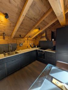 a large kitchen with wooden walls and wooden ceilings at Nevita in Saas-Grund +61 photos
