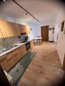 an empty kitchen with a sink and a table at Ferienwohnung Steiner in Scheffau in Scheffau am Wilden Kaiser