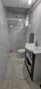 a bathroom with a sink and a toilet at Pousada Familiar 03 in Rio do Sul