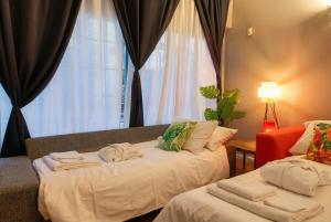 a bedroom with two beds with towels on them at Navigli Experience in Milan
