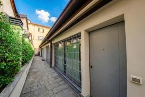 a building with a garage door on the side of it at Navigli Experience in Milan