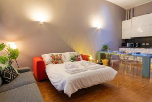 a living room with a bed and a kitchen at Navigli Experience in Milan