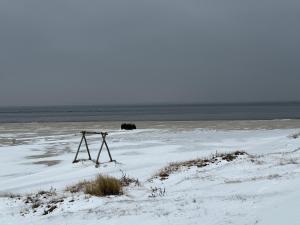 a tripod in the snow on a beach at Villa Meeresglück in Dornum