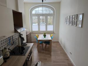a kitchen with a table and chairs in a room at Villa Meeresglück in Dornum +9 photos