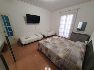 a bedroom with a bed and a flat screen tv at A casa di Picci in Avola