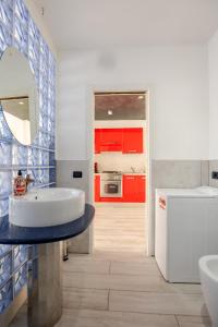 a bathroom with a tub and a sink and red cabinets at Fratelli Bandiera in Latina +20 photos