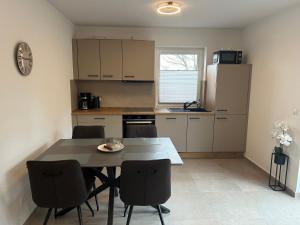 a kitchen with a table and chairs in a room at Seeidylle in Geeste
