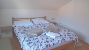 a bed with two pillows and two towels on it at N&M Mountain Escape in Kupres