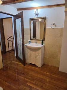 a bathroom with a sink and a mirror at Bucharest Boutique Accommodation by Hotels in Bucharest +127 photos