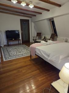 a bedroom with a bed and a flat screen tv at Bucharest Boutique Accommodation by Hotels in Bucharest