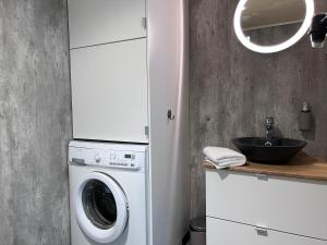 a kitchen with a washing machine and a sink at Blue House Odda in Odda
