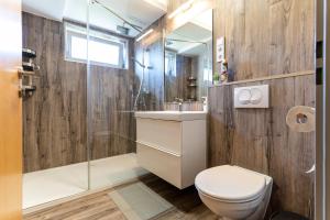 a bathroom with a toilet and a sink and a shower at KJB Vendégház Dombori in Fadd-Dombori