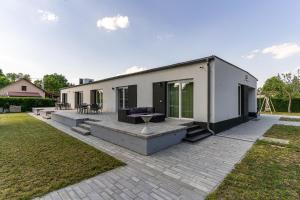 a modular house with a patio in a yard at KJB Vendégház Dombori in Fadd-Dombori