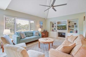 a living room with two couches and a tv at Spinnaker 716 in Seabrook Island
