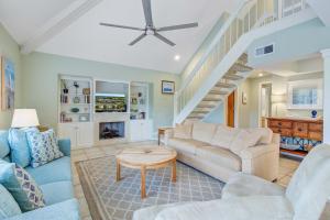 a living room with a couch and a table at Spinnaker 716 in Seabrook Island +22 photos