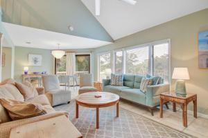 a living room with a couch and a table at Spinnaker 716 in Seabrook Island