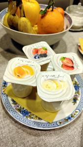 a plate with eggs and fruit on a table at Oasi Brembate Bed and Breakfast in Brembate