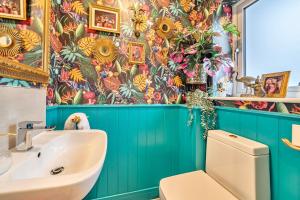 a bathroom with a toilet and a sink at Winterbourne House in Fleet +23 photos