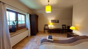 a bedroom with a bed and a window and a table at Tulin in Wetlina