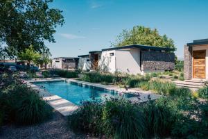 a pool in the backyard of a house with plants at Boutique Hotel Bodega CICLO ANDINO in Perdriel