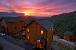an aerial view of a house with the sunset in the background at Hibearnator in Sevierville