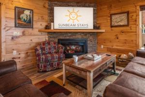 a living room with a fireplace in a cabin at Hibearnator in Sevierville