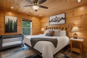 a bedroom with a bed and a ceiling fan at Hibearnator in Sevierville +14 photos