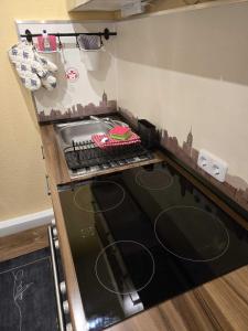 a kitchen with a stove with a cake on it at Ferienwohnung Salut in Saarbrücken +43 photos