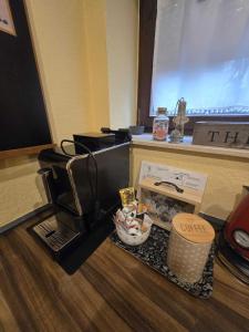 a coffee maker and a box on a table at Ferienwohnung Salut in Saarbrücken