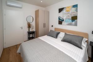 a bedroom with a bed and a mirror at Beachfront house Miamore - 10 m from the sea in Pašman +39 photos