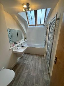a bathroom with a sink and a bath tub at Turfhill House in New Deer +25 photos