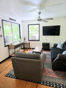 a living room with two couches and a flat screen tv at Cozy Cabin 2 beds Mtn view in Franklin