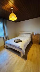 a bedroom with a bed and a wooden floor at BALLYHOURA, Kildorrery, Beautiful 5 bed quite convenient location in Kildorrery