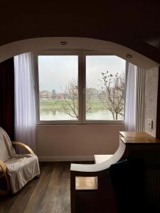 a room with a window with a view of a river at Riverside Apartment in Lugoj