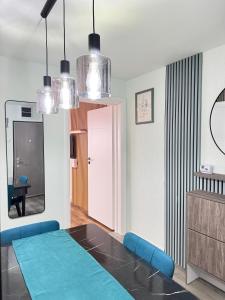 a living room with a blue couch and a table at Riverside Apartment in Lugoj
