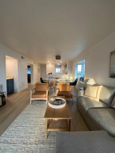 a living room with a couch and a table at Pearl on the Point in Carolina Beach